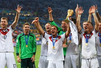 RIO DE JANEIRO, BRAZIL - JULY 13:  Mario Goetze of Germany raises the World Cup trophy with teammates Per Mertesacker, Ron-Robert Zieler, Shkodran Mustafi, Roman Weidenfeller, Mats Hummels and Bastian Schweinsteiger during the 2014 FIFA World Cup Brazil F