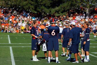 ENGLEWOOD, CO - JULY 26:  Quarterbacks Peyton Manning #18, Brock Osweiler #6 and Caleb Hanie #16 of the Denver Broncos talk during training camp at the Paul D. Bowlen Memorial Broncos Centre at Dove Valley on July 26, 2012 in Englewood, Colorado.  (Photo 