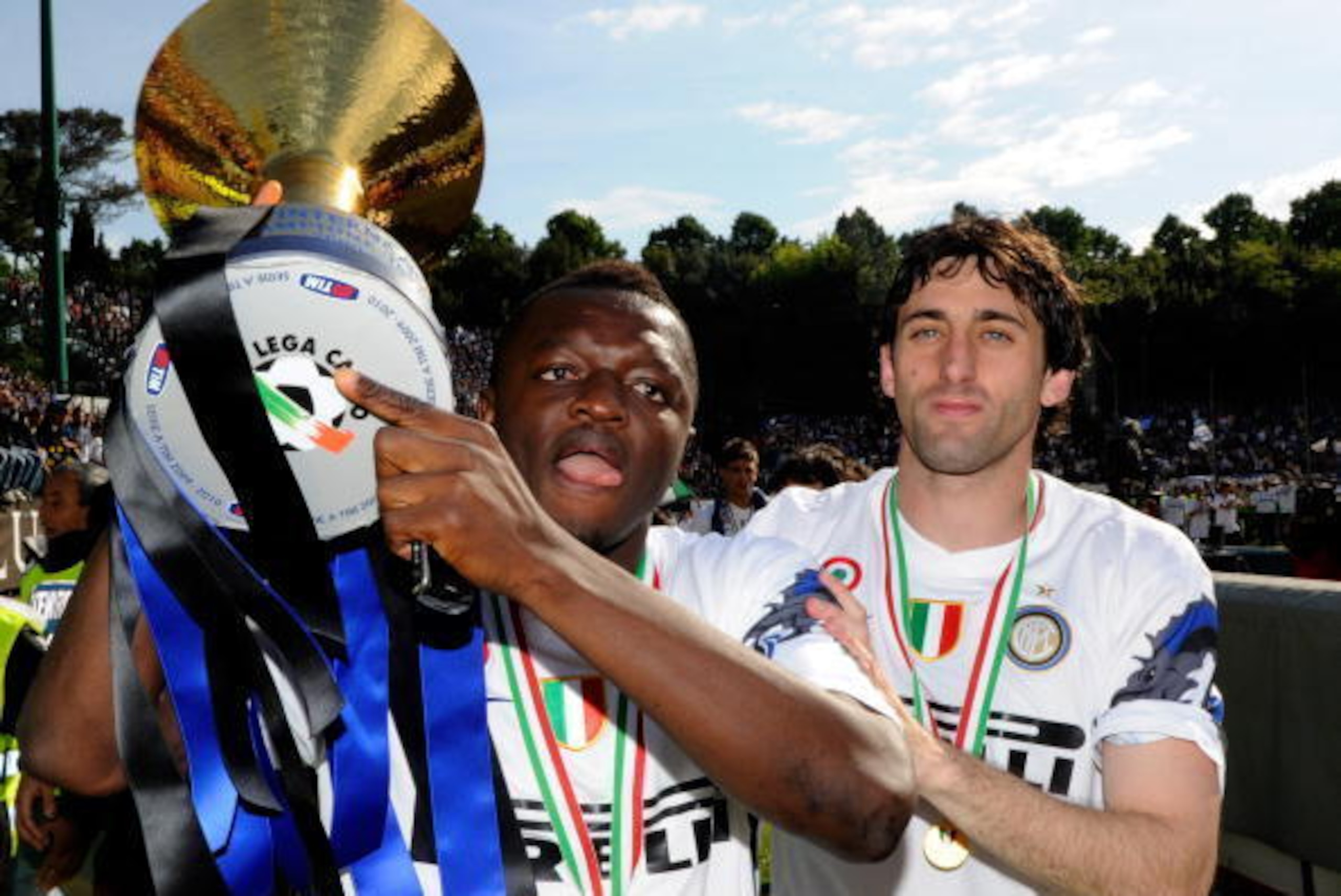 SIENA, ITALY - MAY 16:  Sulley Muntari and Diego Alberto Milito of FC Internazionale Milano celebrate with the league trophy after the Serie A match between AC Siena and FC Internazionale Milano at Stadio Artemio Franchi on May 16, 2010 in Siena, Italy.  