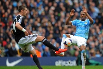 MANCHESTER, ENGLAND - APRIL 05:  Morgan Schneiderlin of Southampton and Fernandinho of Manchester City compete for the ball during the Barclays Premier League match between Manchester City and Southampton at Etihad Stadium on April 5, 2014 in Manchester, 