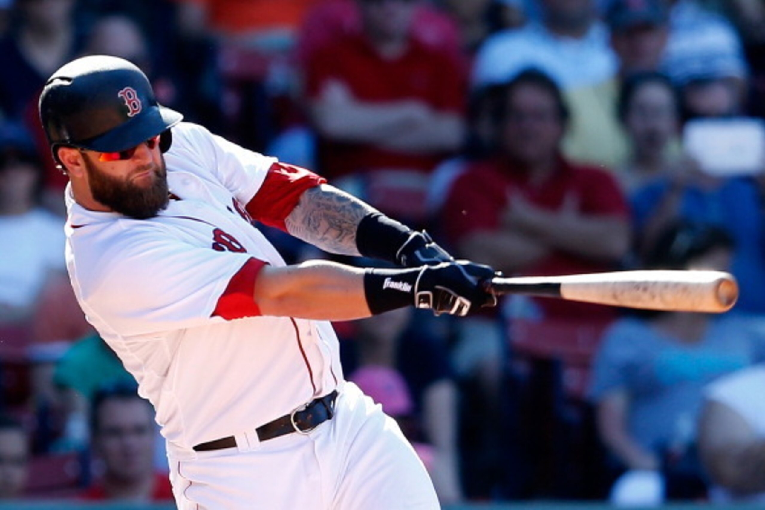 BOSTON, MA - JULY 6:  Mike Napoli #12 of the Boston Red Sox singles in the tying runin the seventh inning against the Baltimore Orioles at Fenway Park on July 6, 2014 in Boston, Massachusetts.  (Photo by Jim Rogash/Getty Images)