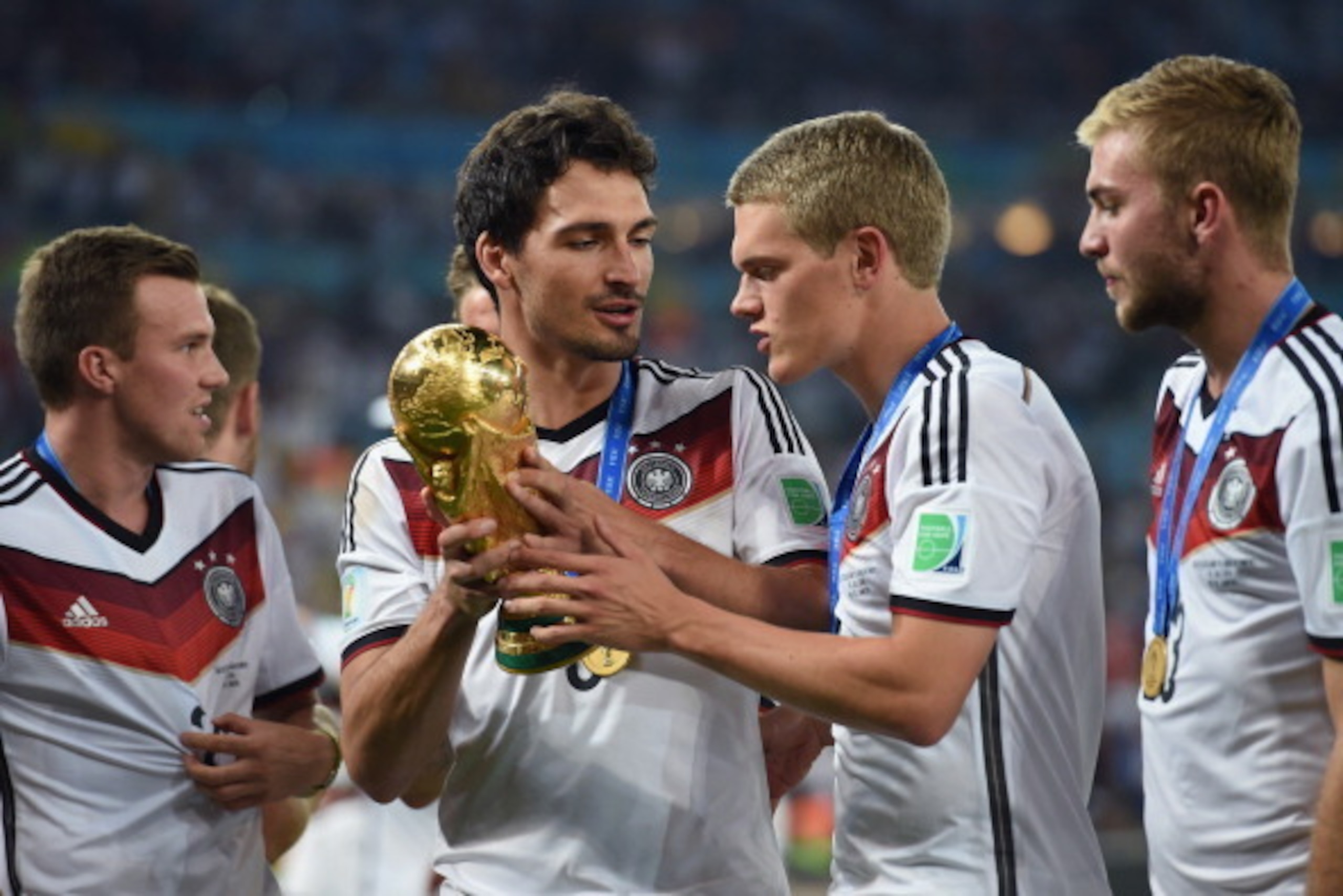 RIO DE JANEIRO, BRAZIL - JULY 13:  Mats Hummels and Matthias Ginter celebrate with the World Cup trophy  after defeating Argentina 1-0 in extra time during the 2014 FIFA World Cup Brazil Final match between Germany and Argentina at Maracana on July 13, 20