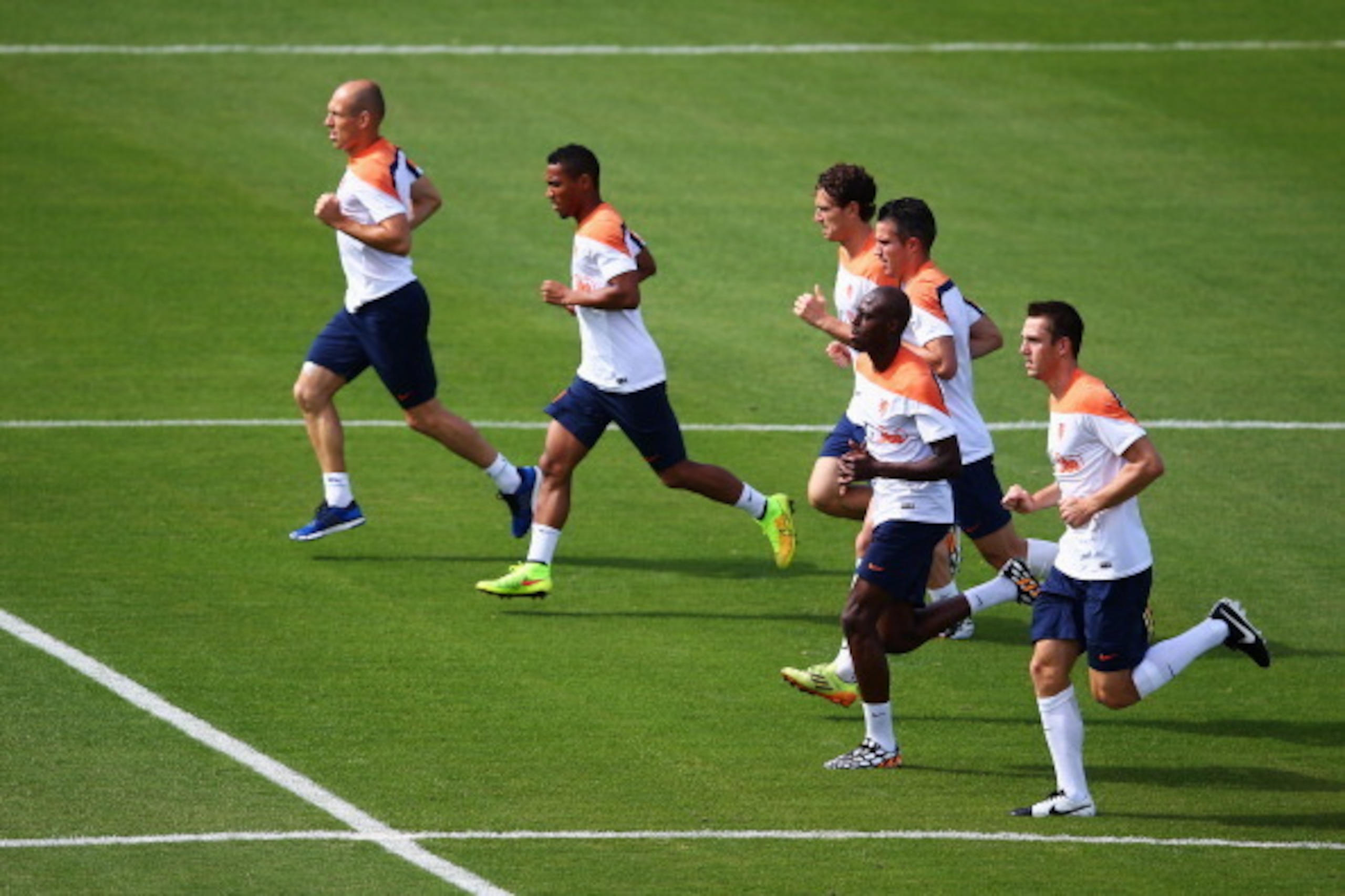 RIO DE JANEIRO, BRAZIL - JUNE 14:  Arjen Robben, Robin van Persie, Bruno Martins Indi, Daryl Janmaat Jonathan de Guzman and Stefan de Vrij warm up during the Netherlands training session at the 2014 FIFA World Cup Brazil held at the Estadio Jose Bastos Pa