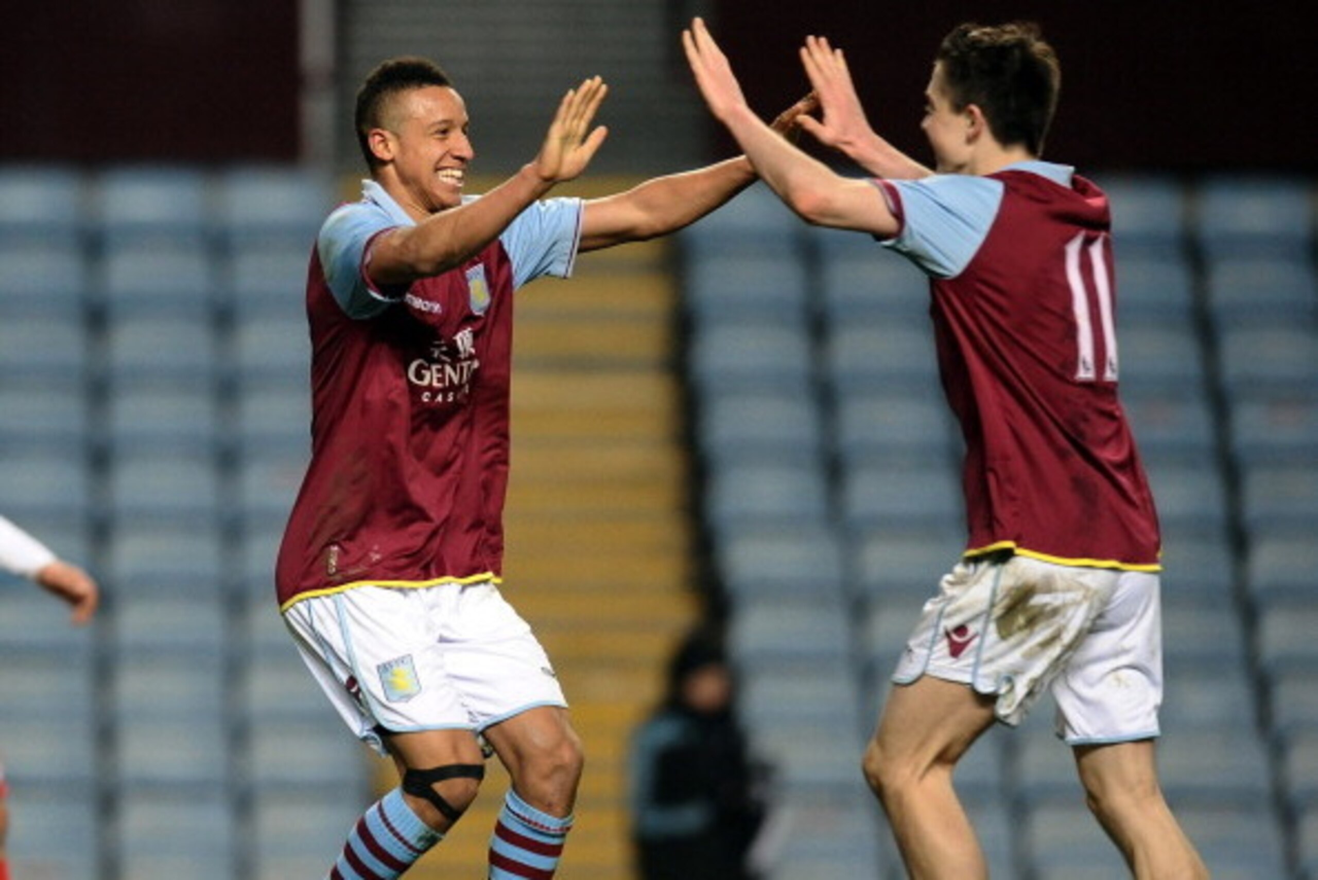 BIRMINGHAM, ENGLAND - MARCH 20: Callum Robinson (L) and Jack Grealish of Aston Villa celebrate their win at the end of the NextGen Series Quarter Final match between Aston Villa U19 and Olympiacos U19 at Villa Park on March 20, 2013 in Birmingham, England