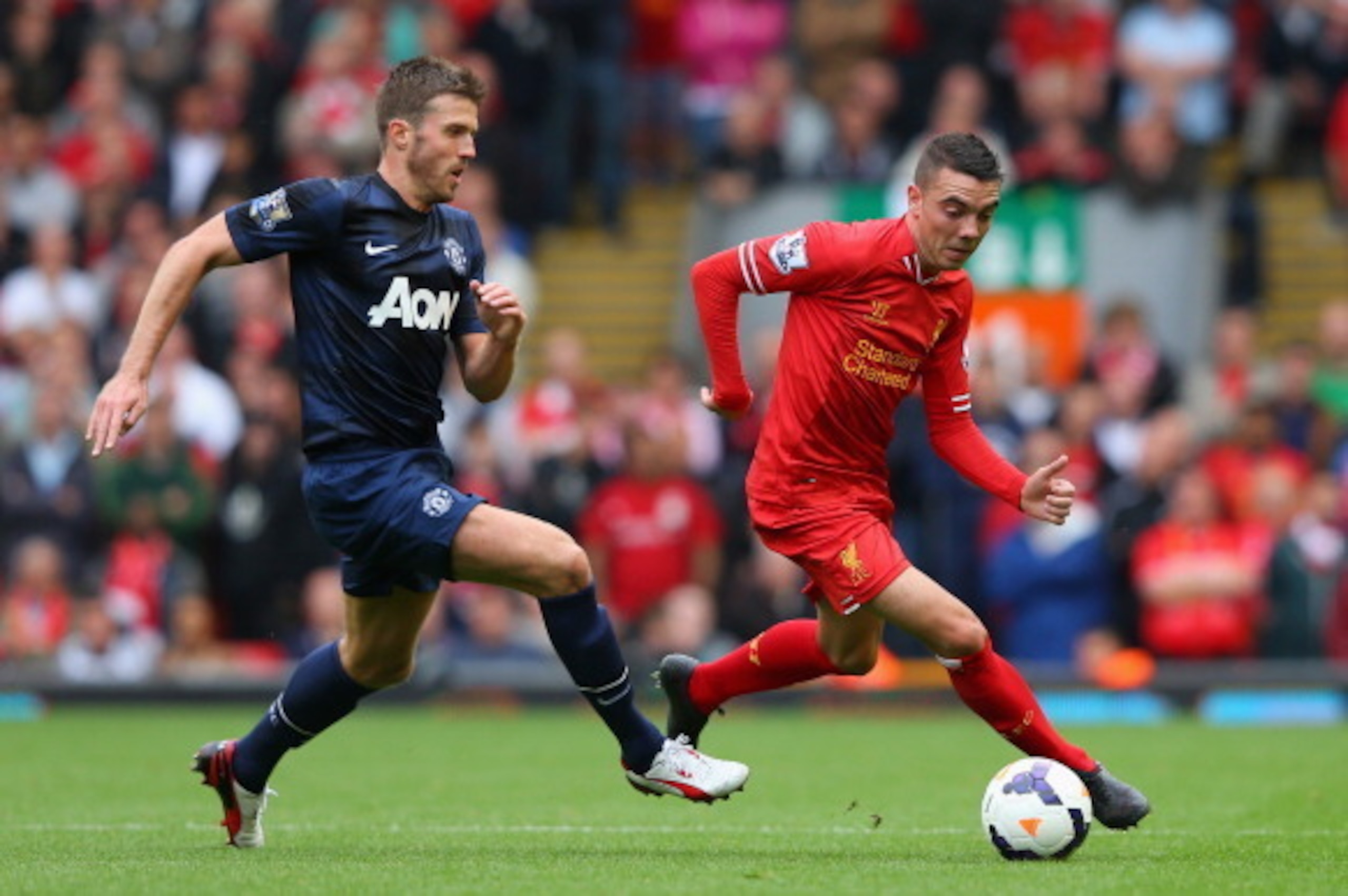LIVERPOOL, ENGLAND - SEPTEMBER 01:  Iago Aspas of Liverpool competes with Michael Carrick of Manchester United during the Barclays Premier League match between Liverpool and Manchester United at Anfield on September 01, 2013 in Liverpool, England.  (Photo