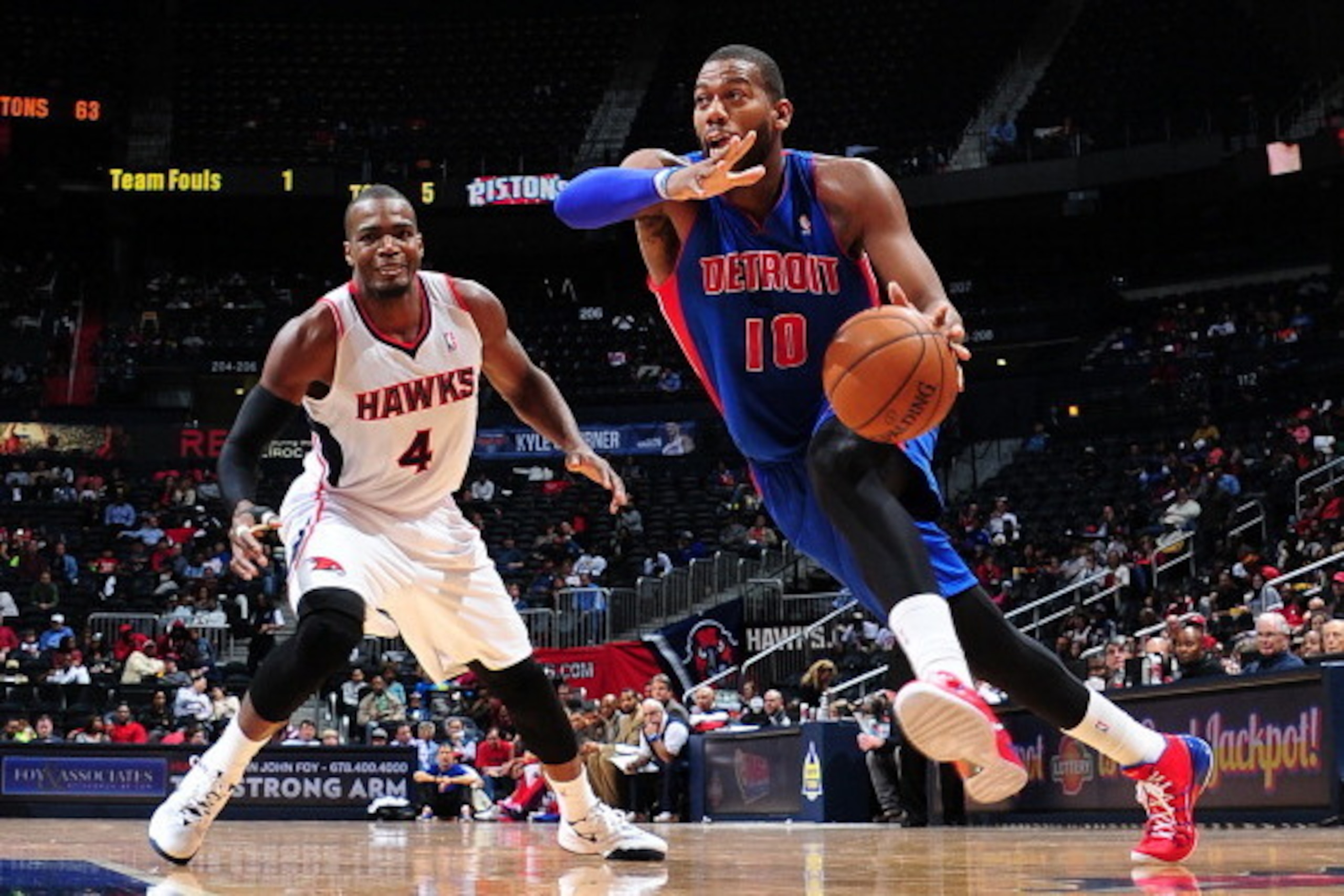 ATLANTA, GA - APRIL 8: Greg Monroe #10 of the Detroit Pistons drives to the basket against Paul Millsap #4 of the Atlanta Hawks on April 8, 2014 at Philips Arena in Atlanta, Georgia.  NOTE TO USER: User expressly acknowledges and agrees that, by downloadi