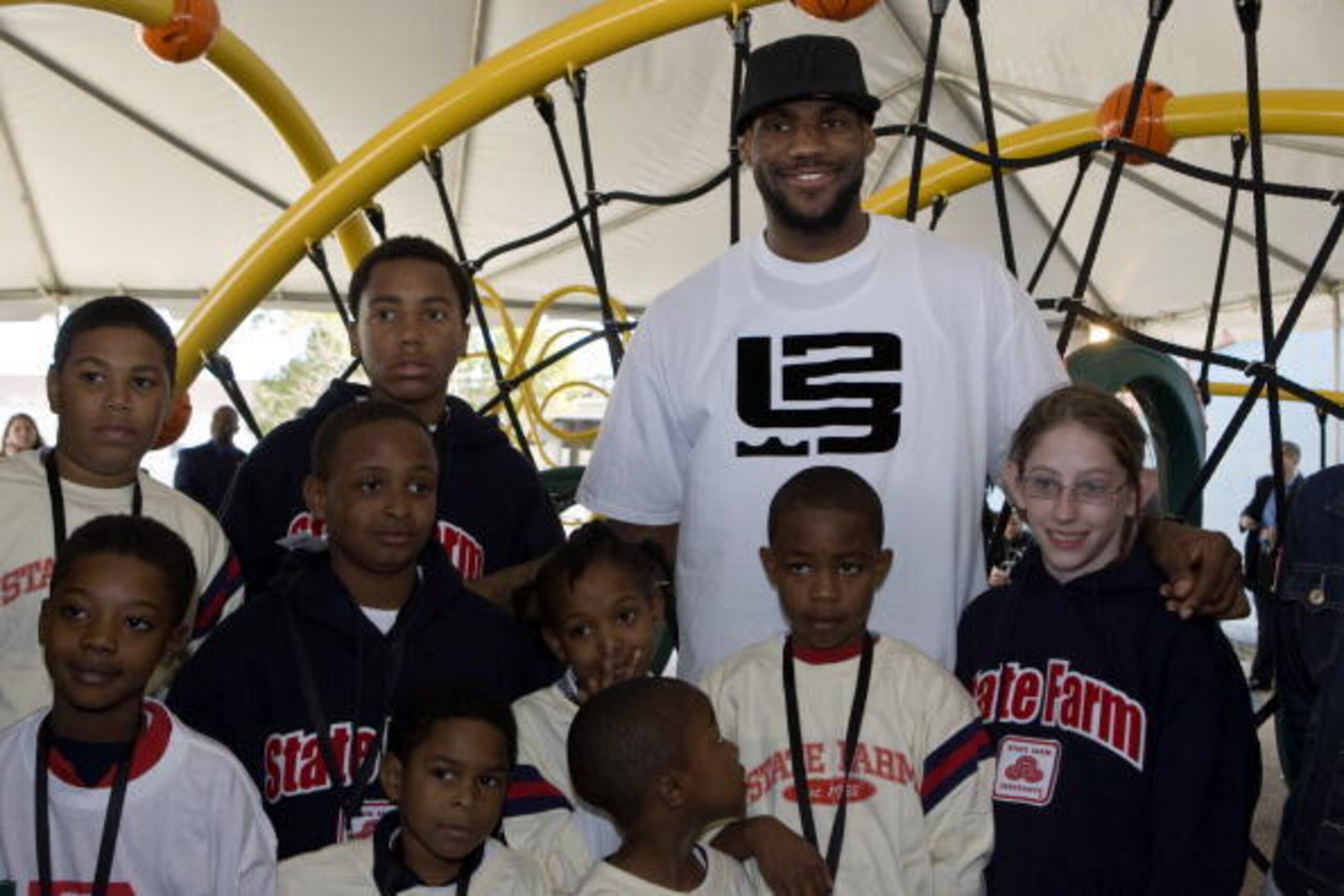 NEW ORLEANS - FEBRUARY 14:  LeBron James of the Cleveland Cavaliers poses with neighborhood children at a playground dedication by State Farm Insurance and the LeBron James Family Foundation at the St. Bernard Recreation Center February 14, 2008 in New Or