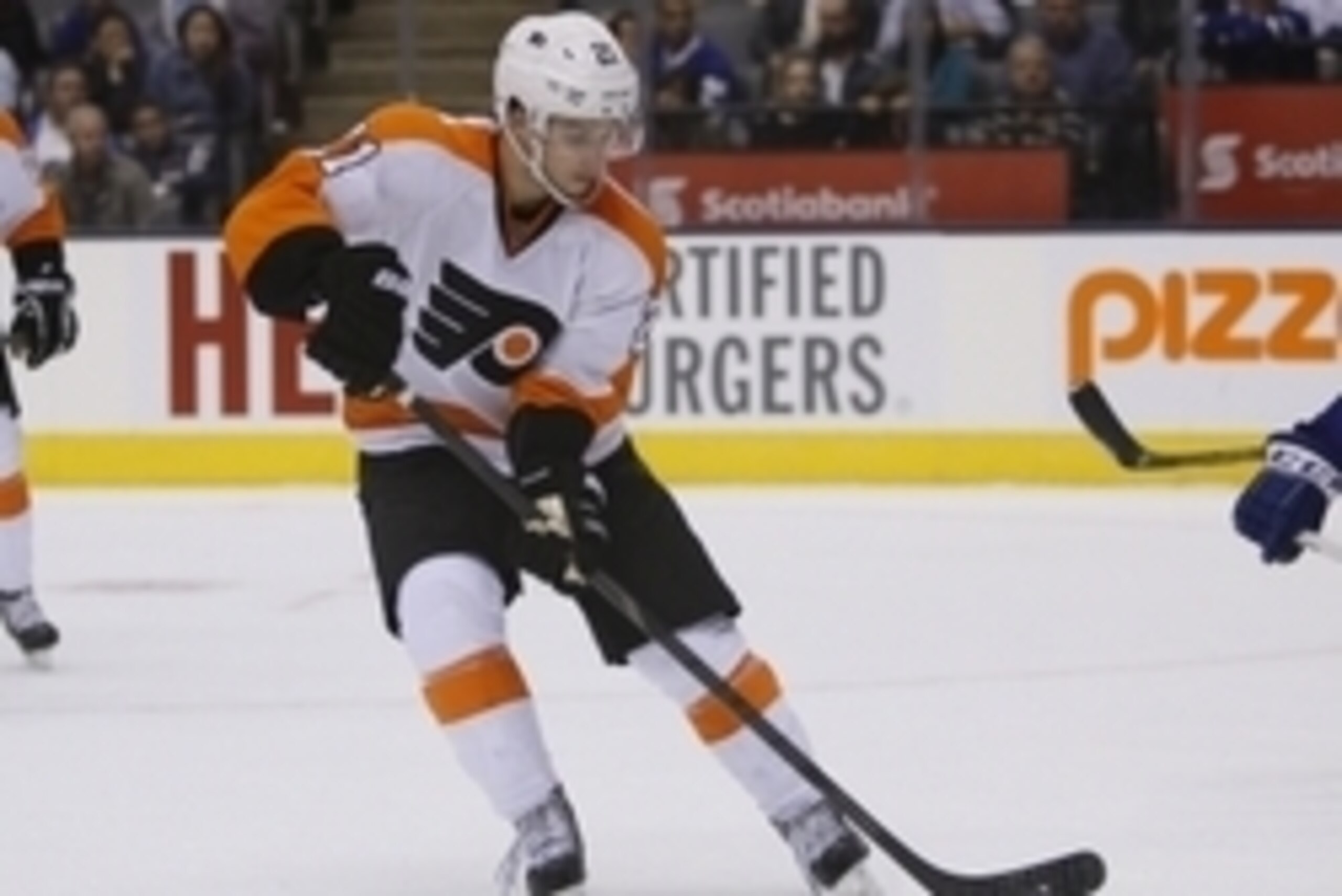 Sep 16, 2013; Toronto, Ontario, CAN; Philadelphia Flyers forward Scott Laughton (21) goes to get a loose puck against the Toronto Maple Leafs at the Air Canada Centre. Philadelphia defeated Toronto 3-2 in an overtime shoot out. Mandatory Credit: John E. S