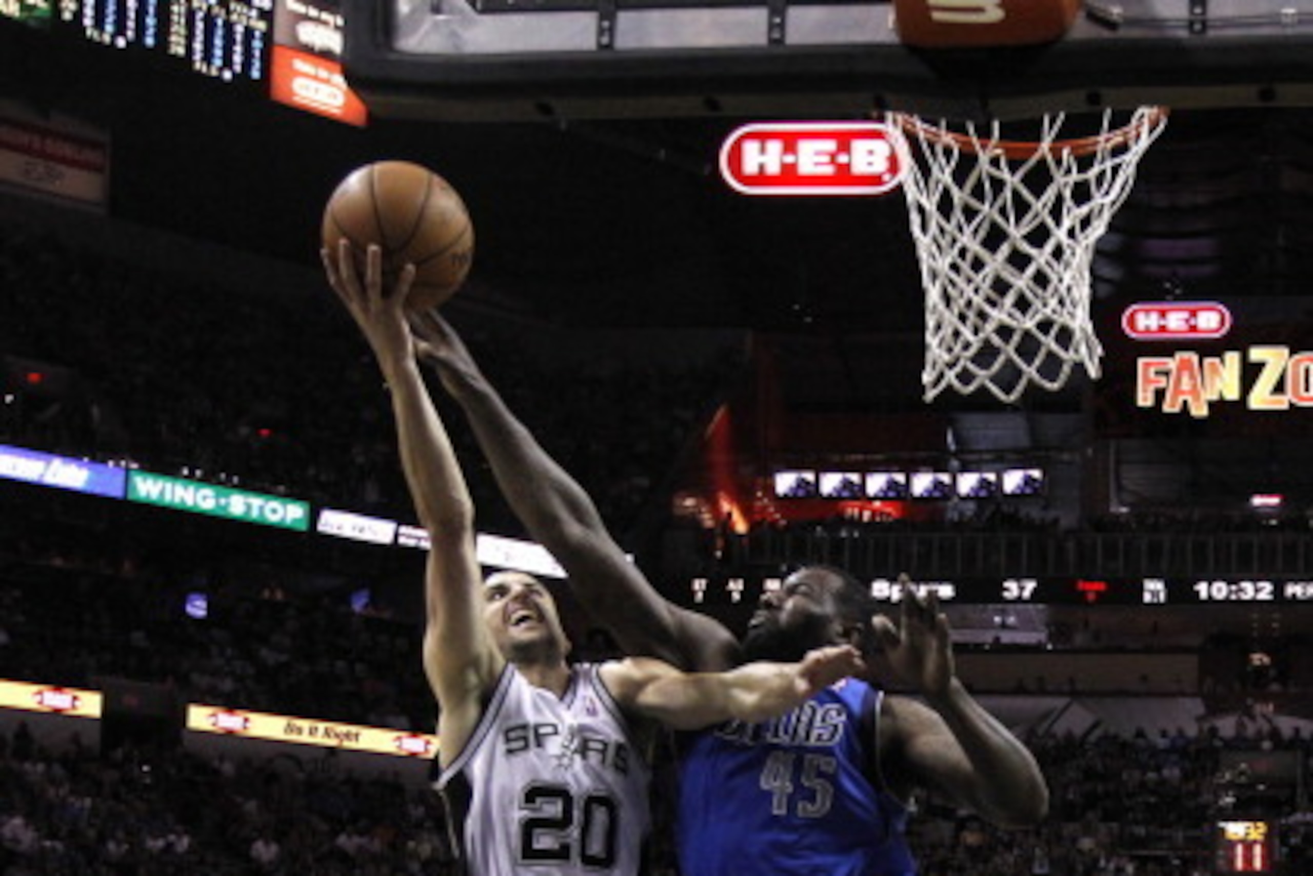 SAN ANTONIO, TX - MAY 4:  Manu Ginobili #20 of the San Antonio Spurs shoots over DeJaun Blair #45 of the Dallas Mavericks in Game Seven of the Western Conference Quarterfinals during the 2014 NBA Playoffs at the AT&T Center on May 4, 2014 in San Antonio, 