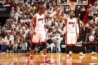 MIAMI, FL - MAY 6: Chris Bosh #1 and Dwyane Wade #3 of the Miami Heat celebrates in Game One of the Eastern Conference Semi-Finals against the Brooklyn Nets during the 2014 NBA Playoffs at American Airlines Arena on May 6, 2014 in Miami, Florida. NOTE TO 