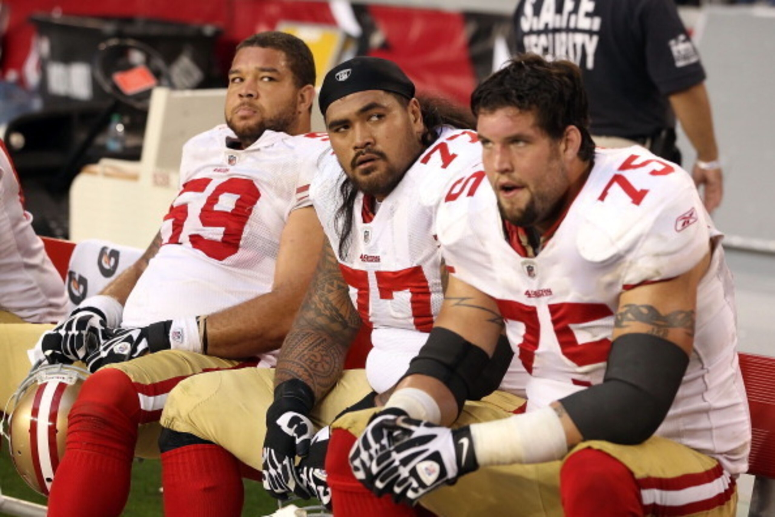 GLENDALE, AZ - DECEMBER 11:  (L-R) Jonathan Goodwin #59,  Mike Iupati #77 and Alex Boone #75 of the San Francisco 49ers react on the bench during the final moments of the NFL game against the Arizona Cardinals at the University of Phoenix Stadium on Decem
