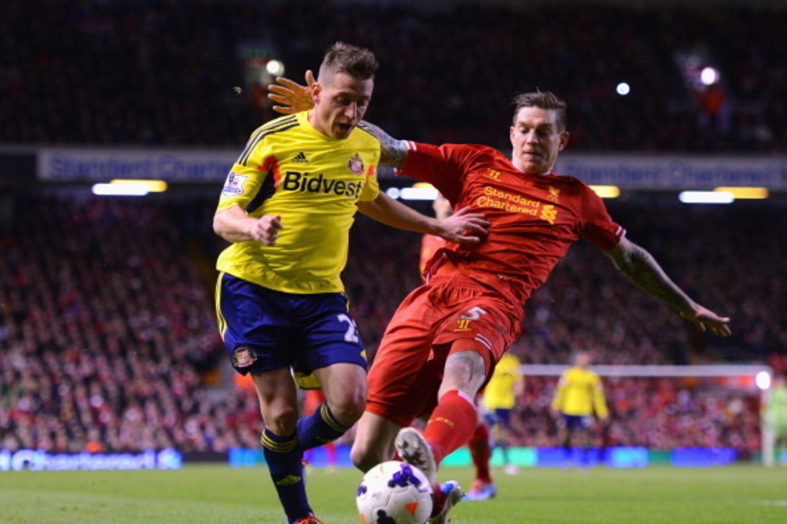 LIVERPOOL, ENGLAND - MARCH 26:  Daniel Agger of Liverpool challenges Emanuele Giaccherini of Sunderland during the Barclays Premier League match between Liverpool and Sunderland at Anfield on March 26, 2014 in Liverpool, England.  (Photo by Michael Regan/