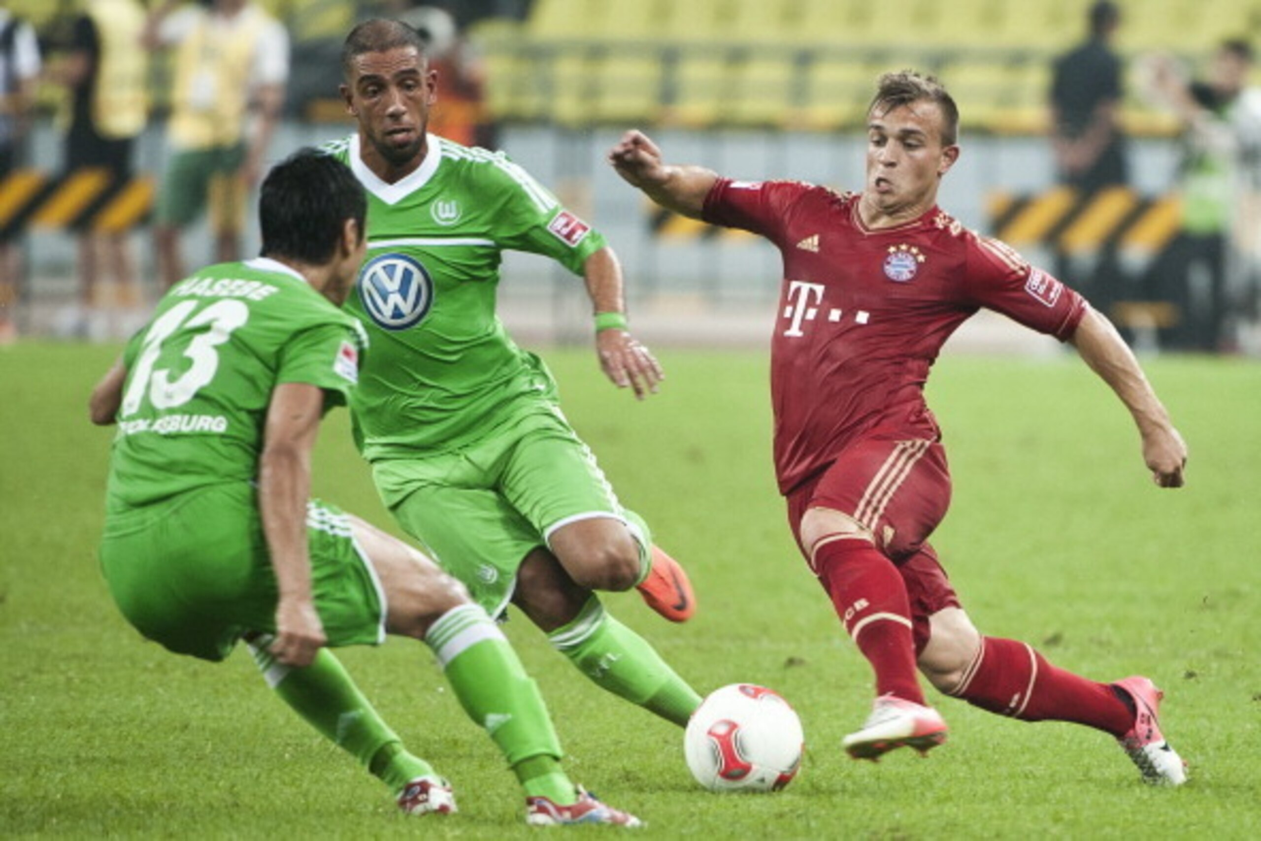GUANGZHOU, GUANGDONG - JULY 26:  Xherdan Shaqiri (R) of Bayern Munich in action during a friendly match against VfL Wolfsburg as part of the Audi Football Summit 2012 on July 26, 2012 at the Guangdong Olympic Sports Center in Guangzhou, China.  (Photo by 