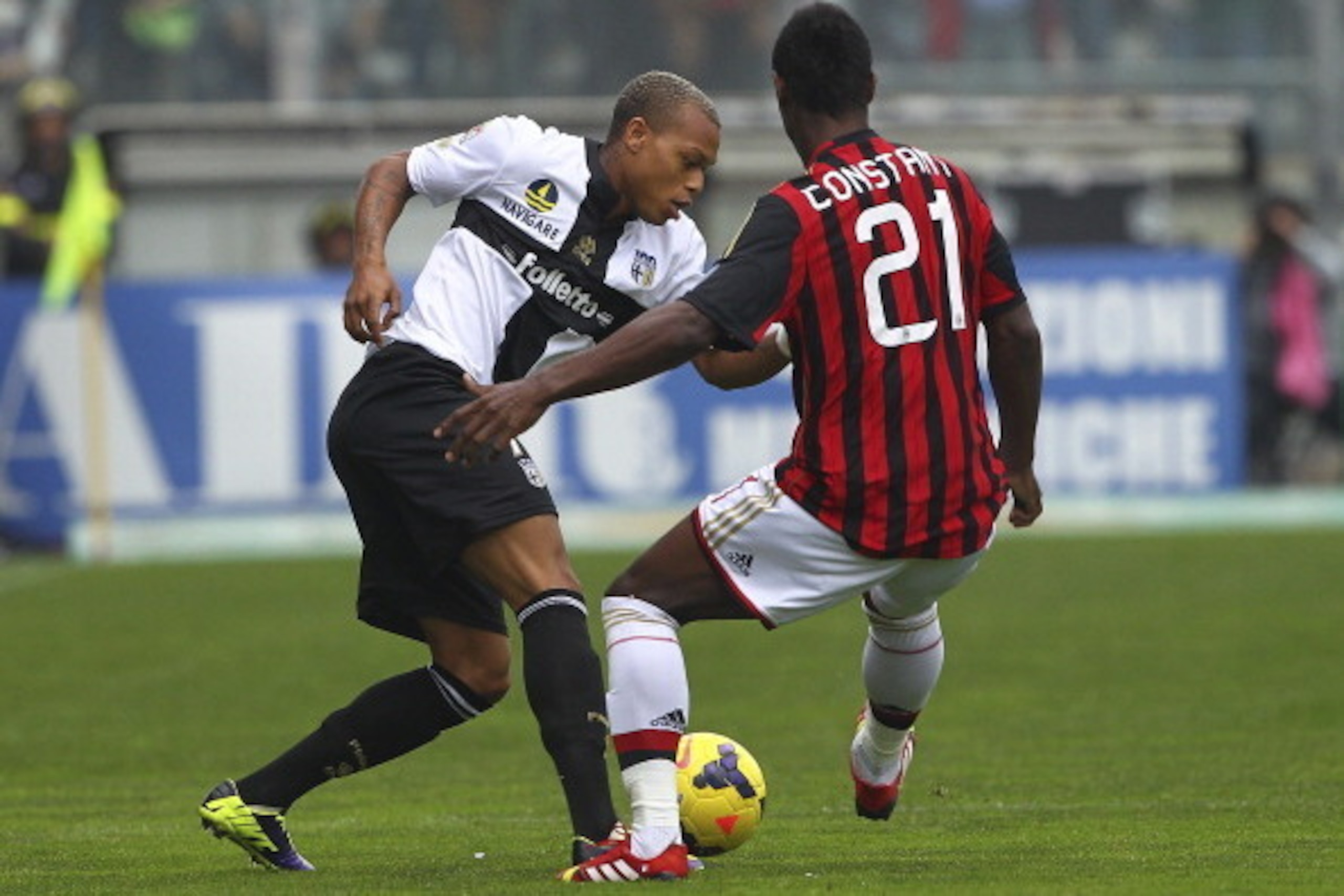 PARMA, ITALY - OCTOBER 27:  Jonathan Biabiany of Parma FC competes for the ball with Kevin Constant of AC Milan during the Serie A match between Parma FC and AC Milan at Stadio Ennio Tardini on October 27, 2013 in Parma, Italy.  (Photo by Marco Luzzani/Ge