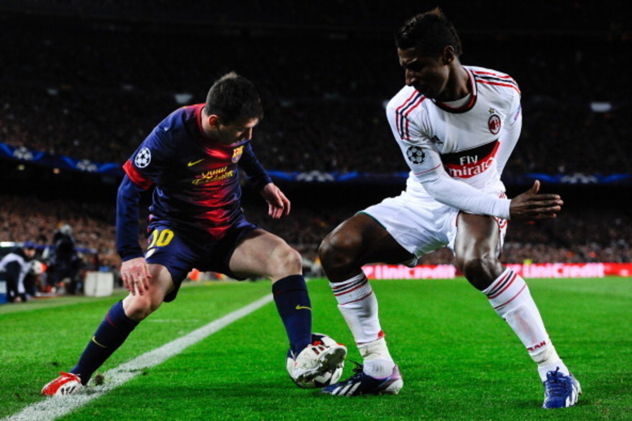 BARCELONA, SPAIN - MARCH 12:  Lionel Messi of FC Barcelona (L) duels for the ball with Kevin Constant of AC Milan during the UEFA Champions League round of 16 second leg match between FC Barcelona and AC Milan at the Camp Nou Stadium on March 12, 2013 in 