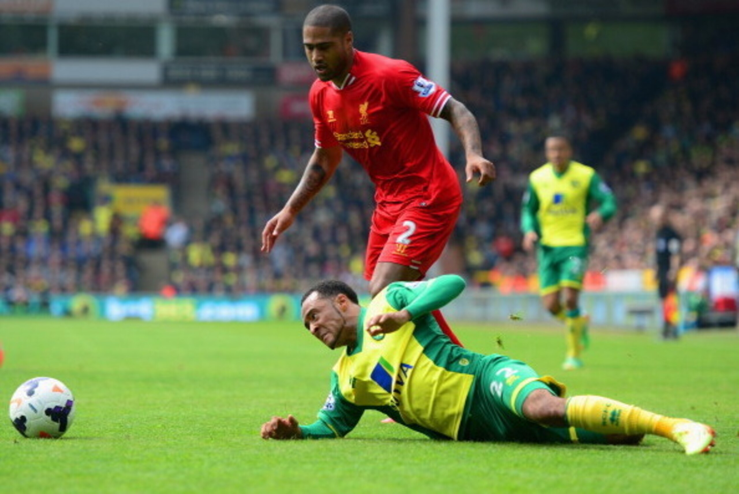 NORWICH, ENGLAND - APRIL 20:  Nathan Redmond of Norwich City clashes with Glen Johnson of Liverpool during the Barclays Premier League match between Norwich City and Liverpool at Carrow Road on April 20, 2014 in Norwich, England.  (Photo by Jamie McDonald