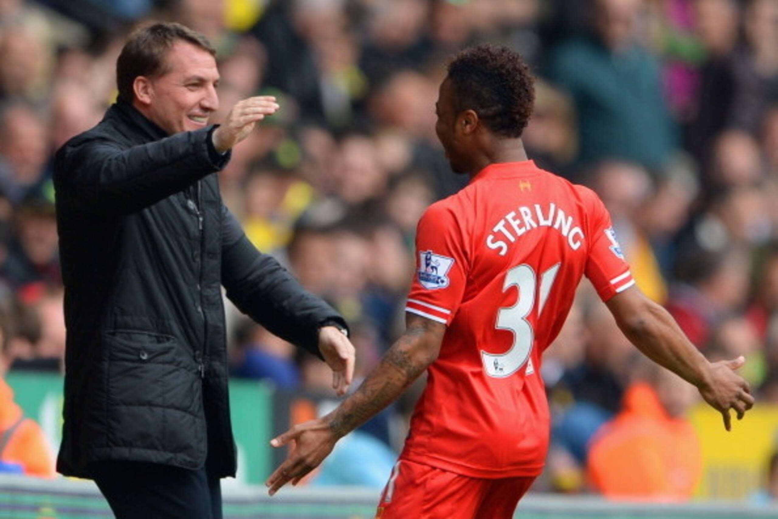 NORWICH, ENGLAND - APRIL 20:  Raheem Sterling of Liverpool celebrates scoring the opening goal with Manager Brendan Rodgers of Liverpool during the Barclays Premier League match between Norwich City and Liverpool at Carrow Road on April 20, 2014 in Norwic