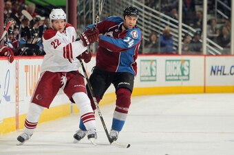 DENVER - JANUARY 06:  Lee Stempniak #22 of the Phoenix Coyotes and Daniel Winnik #34 of the Colorado Avalanche battle for control of the puck at the Pepsi Center on January 6, 2011 in Denver, Colorado. The Coyotes defeated the Avalanche 2-0.  (Photo by Do