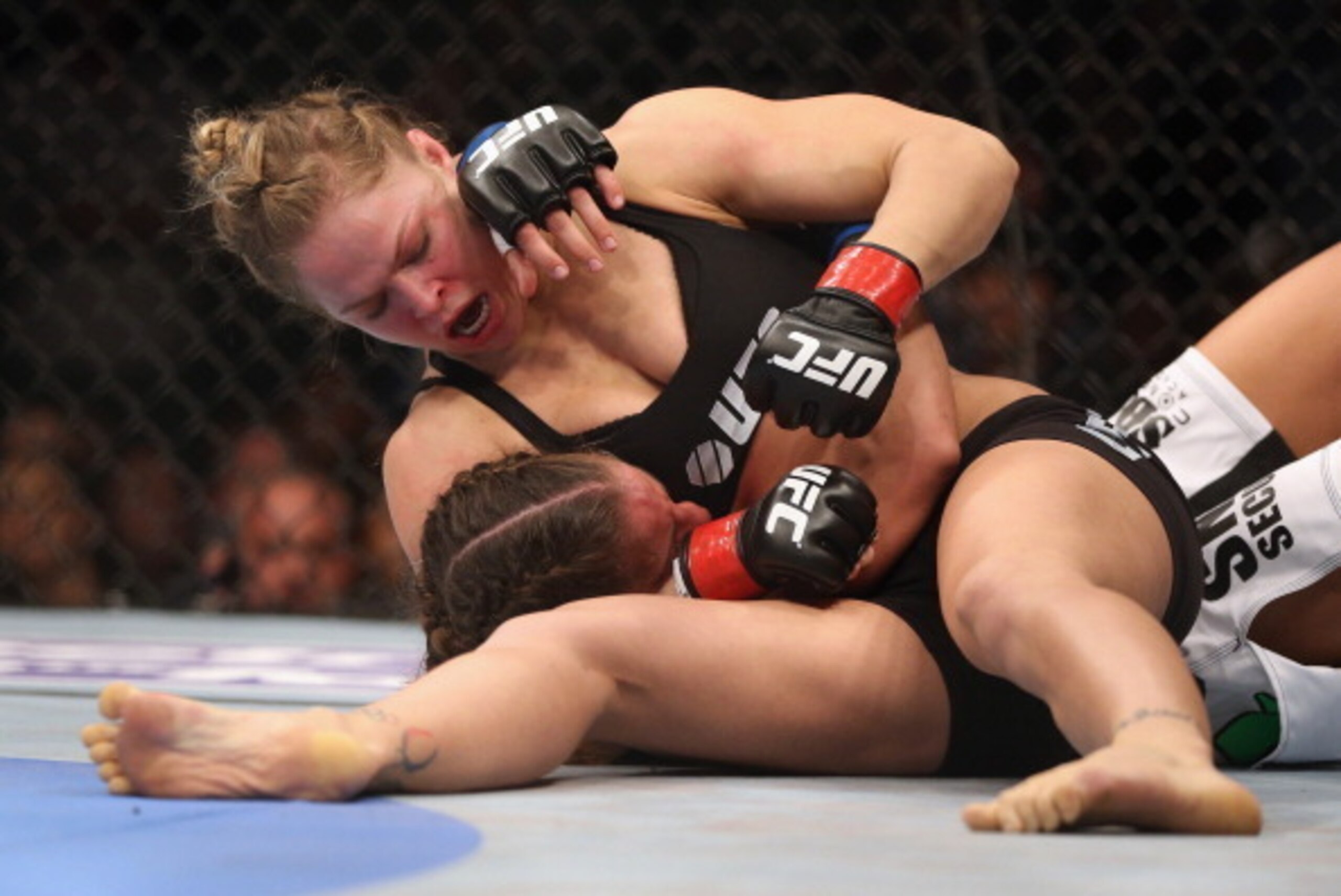 ANAHEIM, CA - FEBRUARY 23:  Ronda Rousey hits Liz Carmouche during their UFC Bantamweight Title fight at Honda Center on February 23, 2013 in Anaheim, California.  (Photo by Jeff Gross/Getty Images)