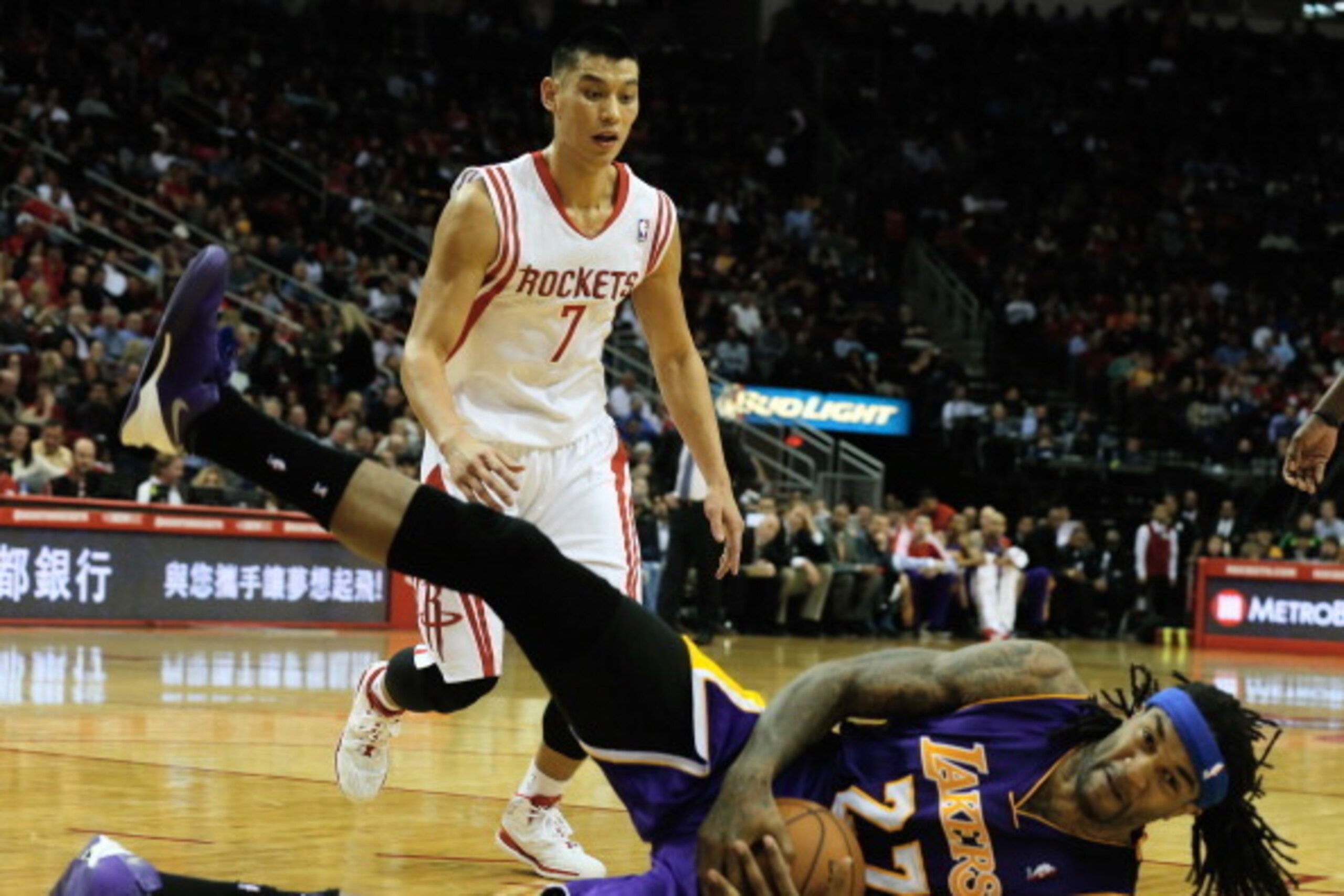 HOUSTON, TX - JANUARY 08:  Jeremy Lin #7 of the Houston Rockets looks down to Jordan Hill #27 of the Los Angeles Lakers during the game at the Toyota Center on January 8, 2014 in Houston, Texas. NOTE TO USER: User expressly acknowledges and agrees that, b