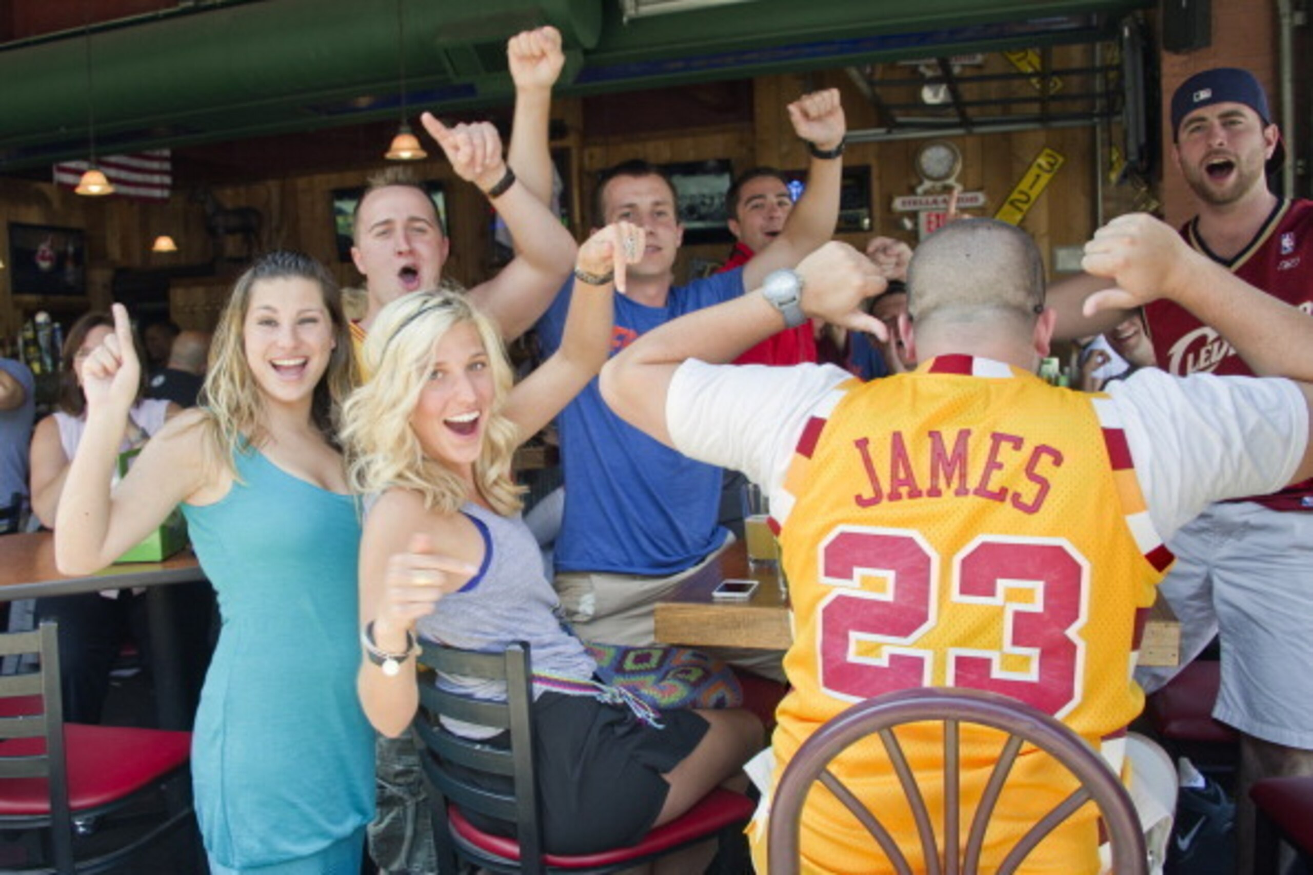 CLEVELAND, OH - JULY 11:  Fans in downtown Cleveland don their #23 LeBron James jerseys and celebrate shortly after he announced his return to the Cleveland Cavaliers on July 11, 2014 in Cleveland, Ohio. NOTE TO USER: User expressly acknowledges and agree