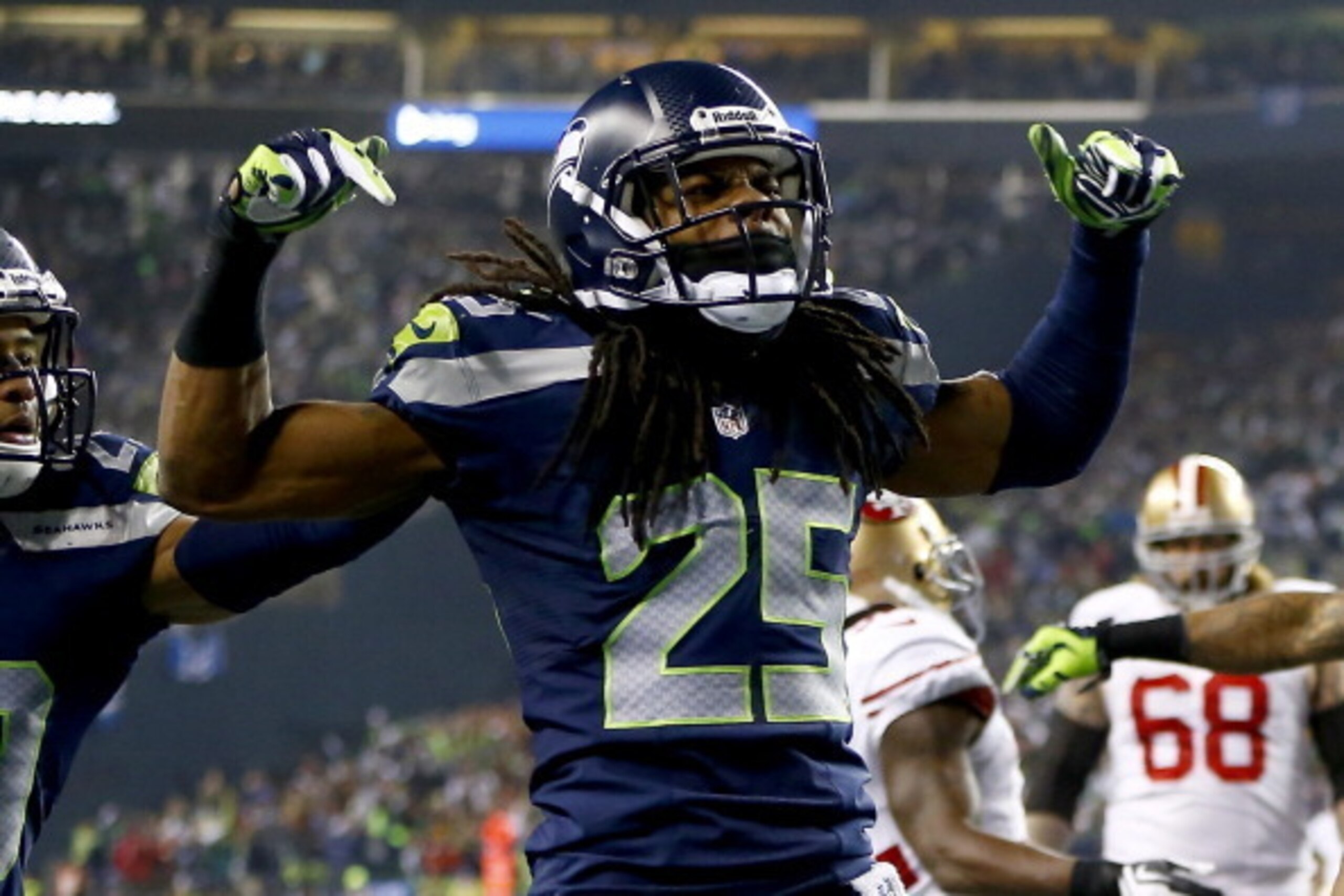 SEATTLE, WA - JANUARY 19:  Cornerback Richard Sherman #25 of the Seattle Seahawks celebrates after he tips the ball leading to an intereption by outside linebacker Malcolm Smith #53 to clinch the victory for the Seahawks against the San Francisco 49ers du