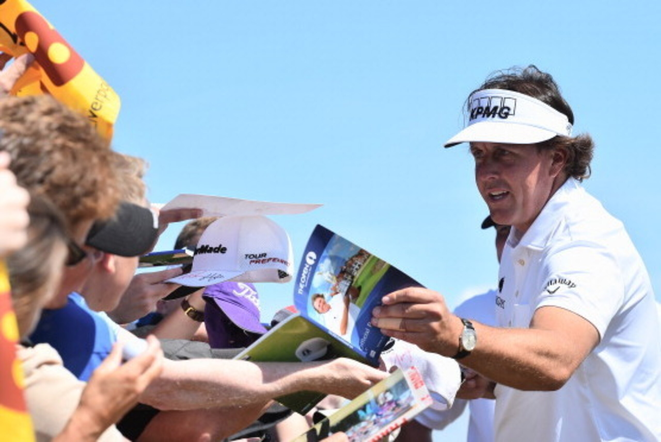 HOYLAKE, ENGLAND - JULY 15:  Phil Mickelson of the United States signs autographs for fans during a practice round prior to the start of The 143rd Open Championship at Royal Liverpool on July 15, 2014 in Hoylake, England.  (Photo by Stuart Franklin/Getty