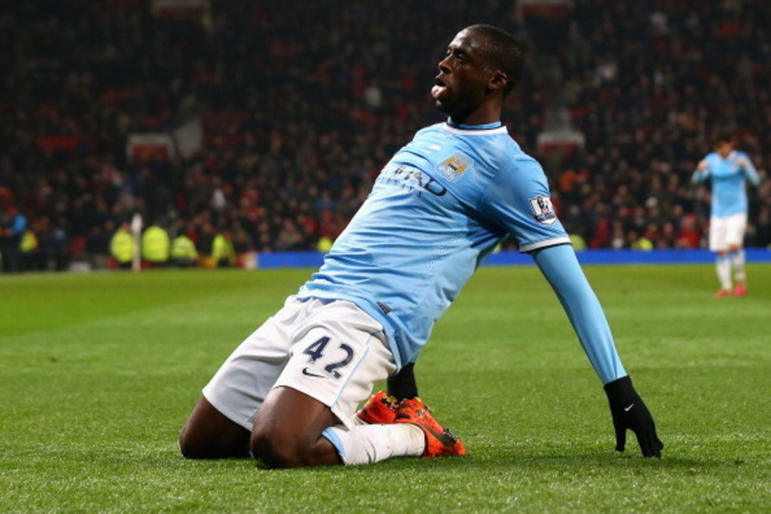 MANCHESTER, ENGLAND - MARCH 25:  Yaya Toure of Manchester City celebrates scoring the third goal during the Barclays Premier League match between Manchester United and Manchester City at Old Trafford on March 25, 2014 in Manchester, England.  (Photo by Al