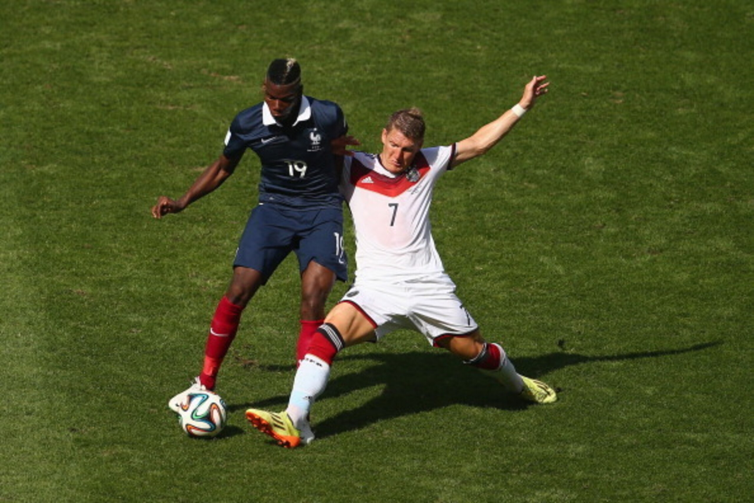 RIO DE JANEIRO, BRAZIL - JULY 04:  Bastian Schweinsteiger of Germany challenges Paul Pogba of France during the 2014 FIFA World Cup Brazil Quarter Final match between France and Germany at Maracana on July 4, 2014 in Rio de Janeiro, Brazil.  (Photo by Cli