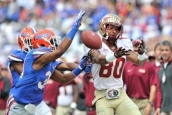 Nov 30, 2013; Gainesville, FL, USA; Florida State Seminoles wide receiver Rashad Greene (80) is unable to make a catch as Florida Gators defensive back Cody Riggs (31) defends the play during the second quarter at Ben Hill Griffin Stadium. Mandatory Credi