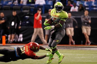 Jan 2, 2014; St. Petersburg, FL, USA;  Team Nitro cornerback Jabrill Peppers (5) runs with the ball as Team Hightlight cornerback  Adoree Jackson (21) defends during the second half at Tropicana Field. Team Highlight defeated the Team Nitro 31-21. Mandato