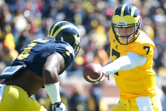 Apr 5, 2014; Ann Arbor, MI, USA; Michigan Wolverines quarterback Shane Morris (7) hands off to running back De'Veon Smith (4) before the Spring Game at Michigan Stadium. Mandatory Credit: Tim Fuller-USA TODAY Sports