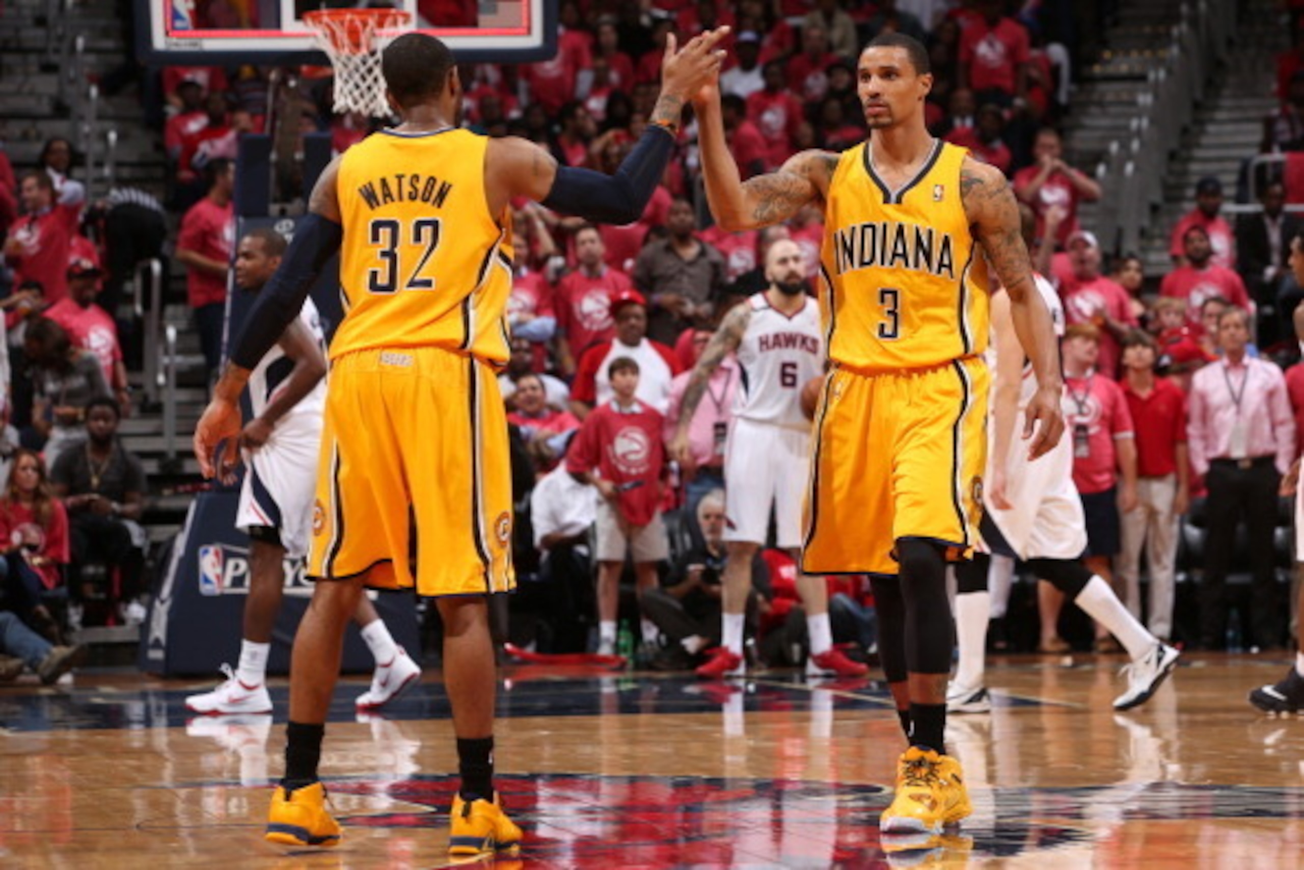 ATLANTA, GA - MAY 1:  George Hill #3 and C.J. Watson #32 of the Indiana Pacers slap hands during a game against the Atlanta Hawks during Game Six of the Eastern Conference Quarterfinals on May 1, 2014 at Philips Arena in Atlanta, Georgia.  NOTE TO USER: U