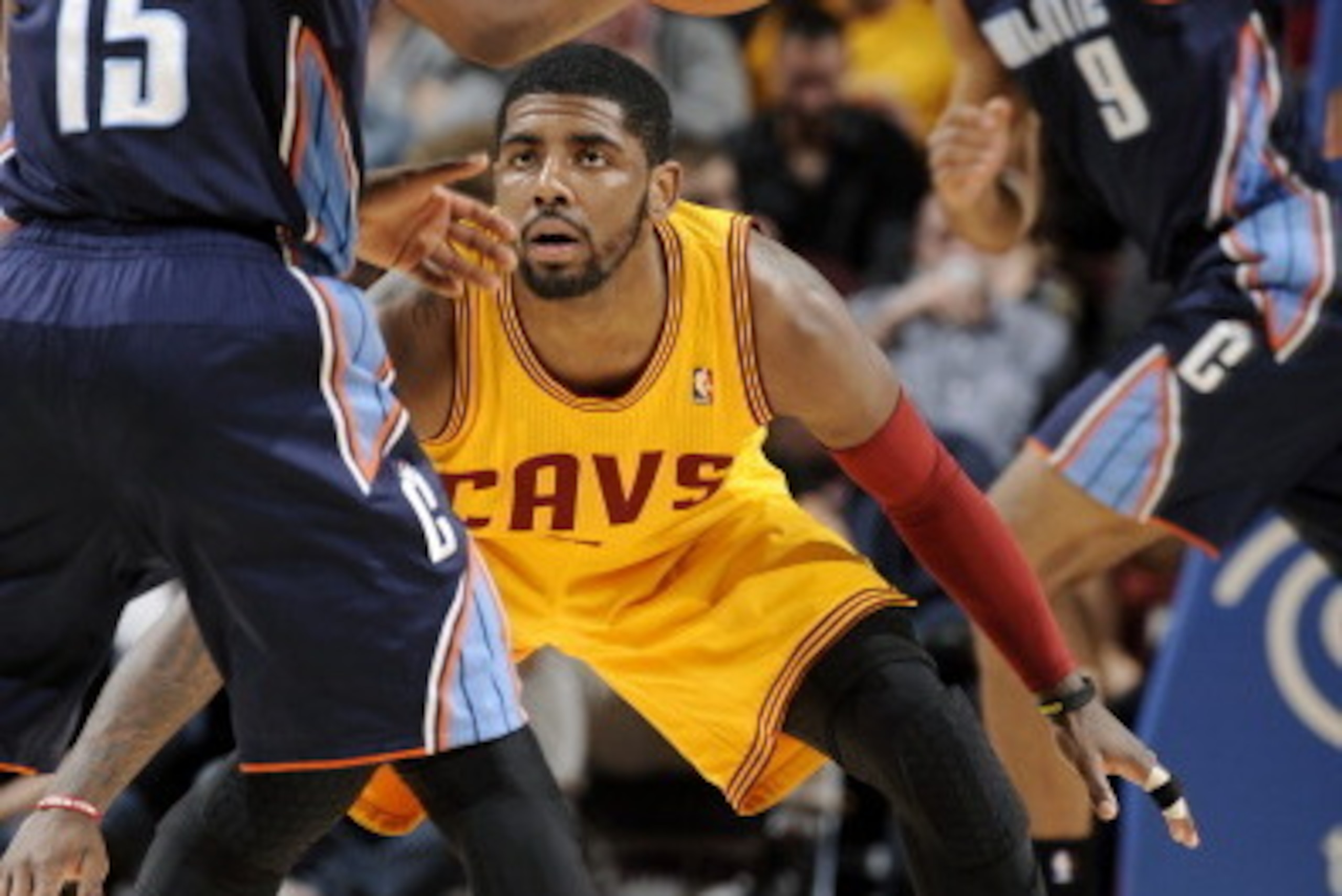 CLEVELAND, OH - APRIL 5:  Kyrie Irving #2 of the Cleveland Cavaliers defends his position against Kemba Walker #15 of the Charlotte Bobcats at The Quicken Loans Arena on April 5, 2014 in Cleveland, Ohio. NOTE TO USER: User expressly acknowledges and agree
