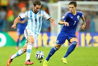 RIO DE JANEIRO, BRAZIL - JUNE 15:  Gonzalo Higuain of Argentina and Muhamed Besic of Bosnia and Herzegovina battle for the ball  during the 2014 FIFA World Cup Brazil Group F match between Argentina and Bosnia-Herzegovina at Maracana on June 15, 2014 in R