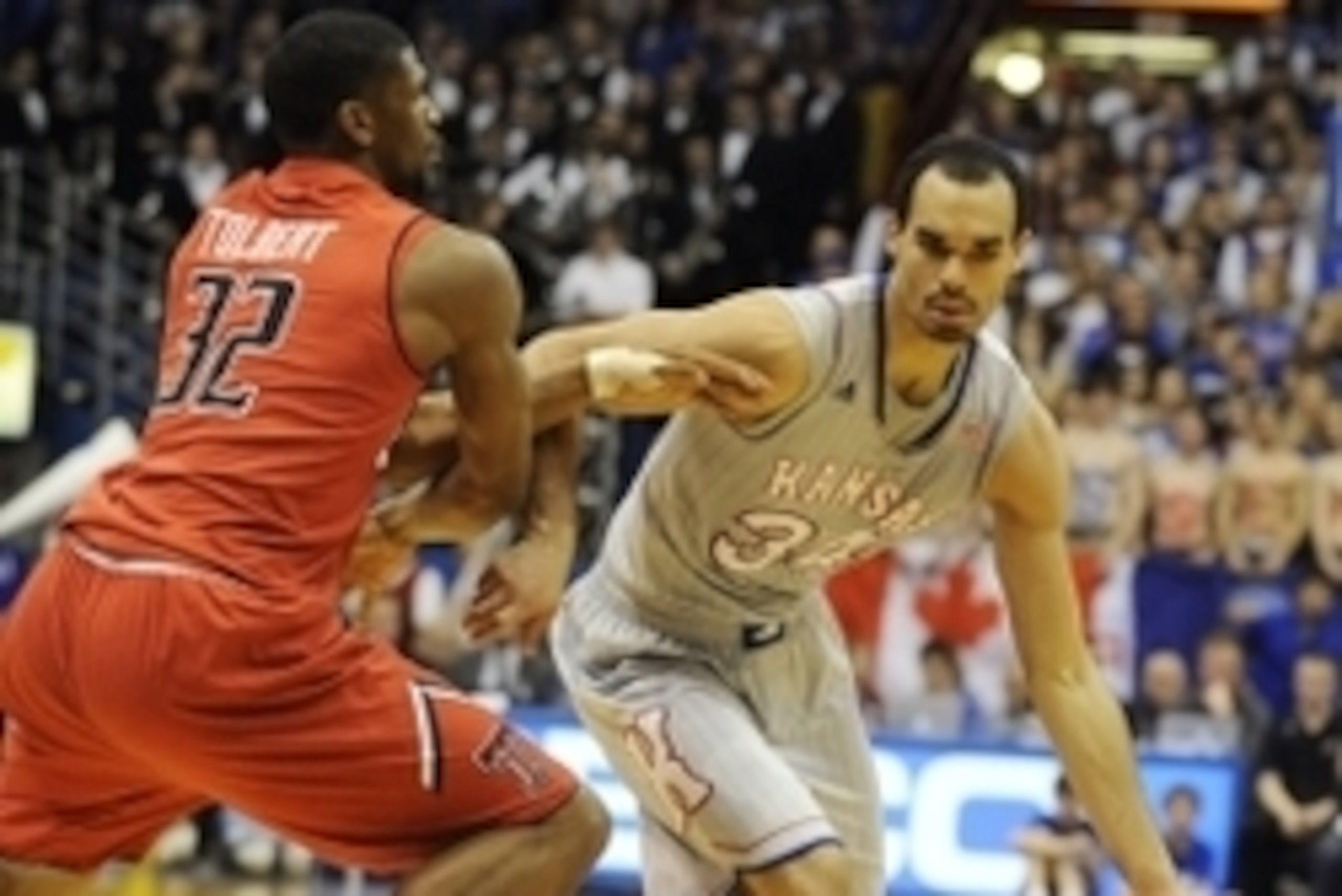 Mar 5, 2014; Lawrence, KS, USA; Kansas Jayhawks forward Perry Ellis (34) drives to the basket against Texas Tech Red Raiders forward Jordan Tolbert (32) in the second half at Allen Fieldhouse. Kansas won the game 82-57. Mandatory Credit: John Rieger-USA T