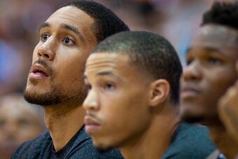 Dwayne Jones, far left, watches the Kings play the Spurs from his seat on the bench.