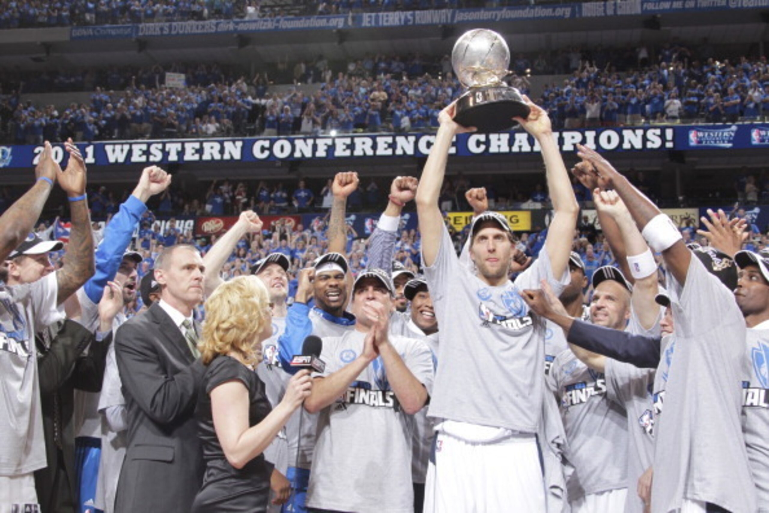 DALLAS, TX - MAY 25: Dirk Nowitzki #41 holds up the trophy in celebration with owner Mark Cuban and the Dallas Mavericks as they celebrate their victory against the Oklahoma City Thunder during Game Five of the Western Conference Finals in the 2011 NBA Pl