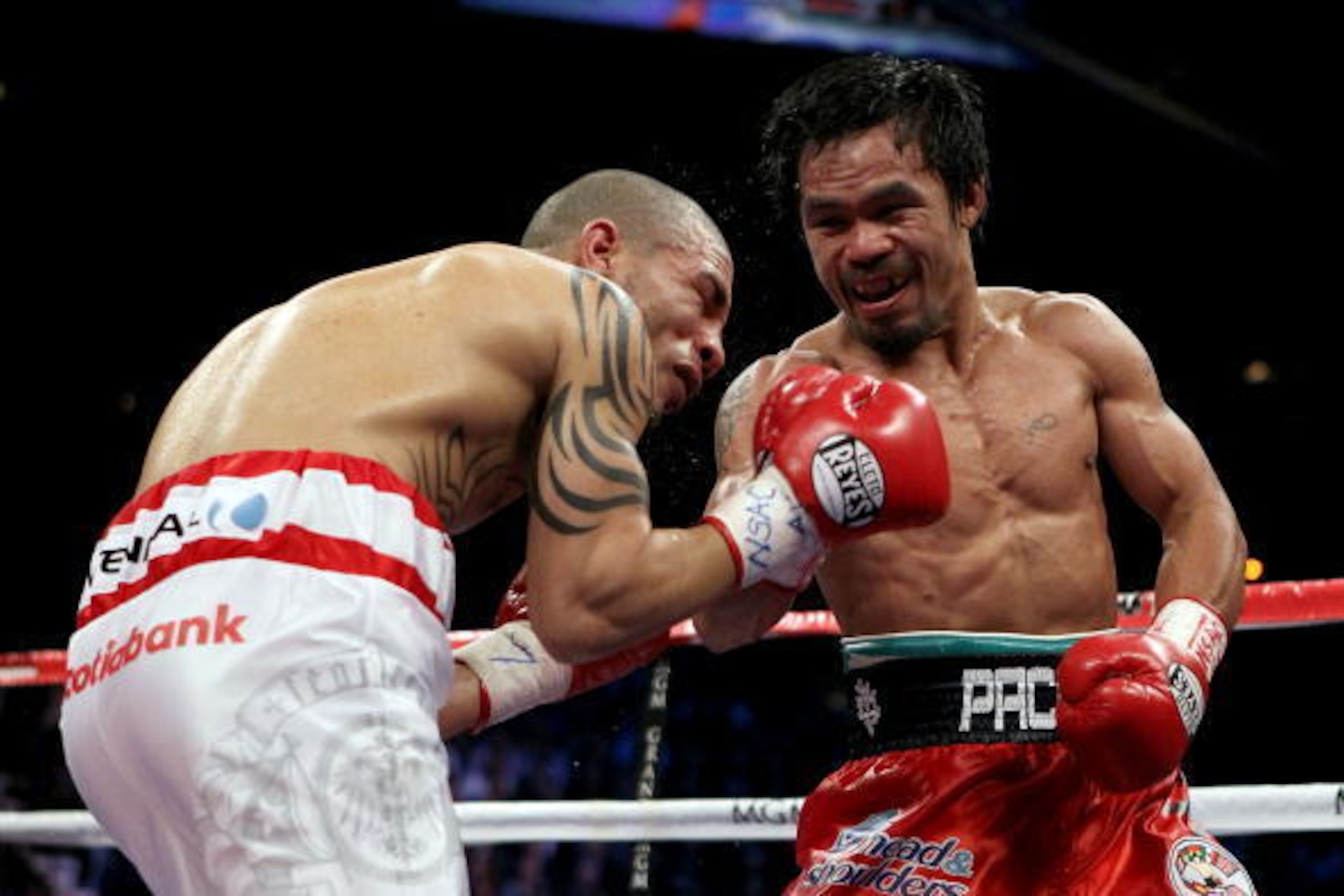 LAS VEGAS - NOVEMBER 14:  (R-L) Manny Pacquiao throws a right to the body of Miguel Cotto during their WBO welterweight title fight at the MGM Grand Garden Arena on November 14, 2009 in Las Vegas, Nevada.  (Photo by Al Bello/Getty Images)