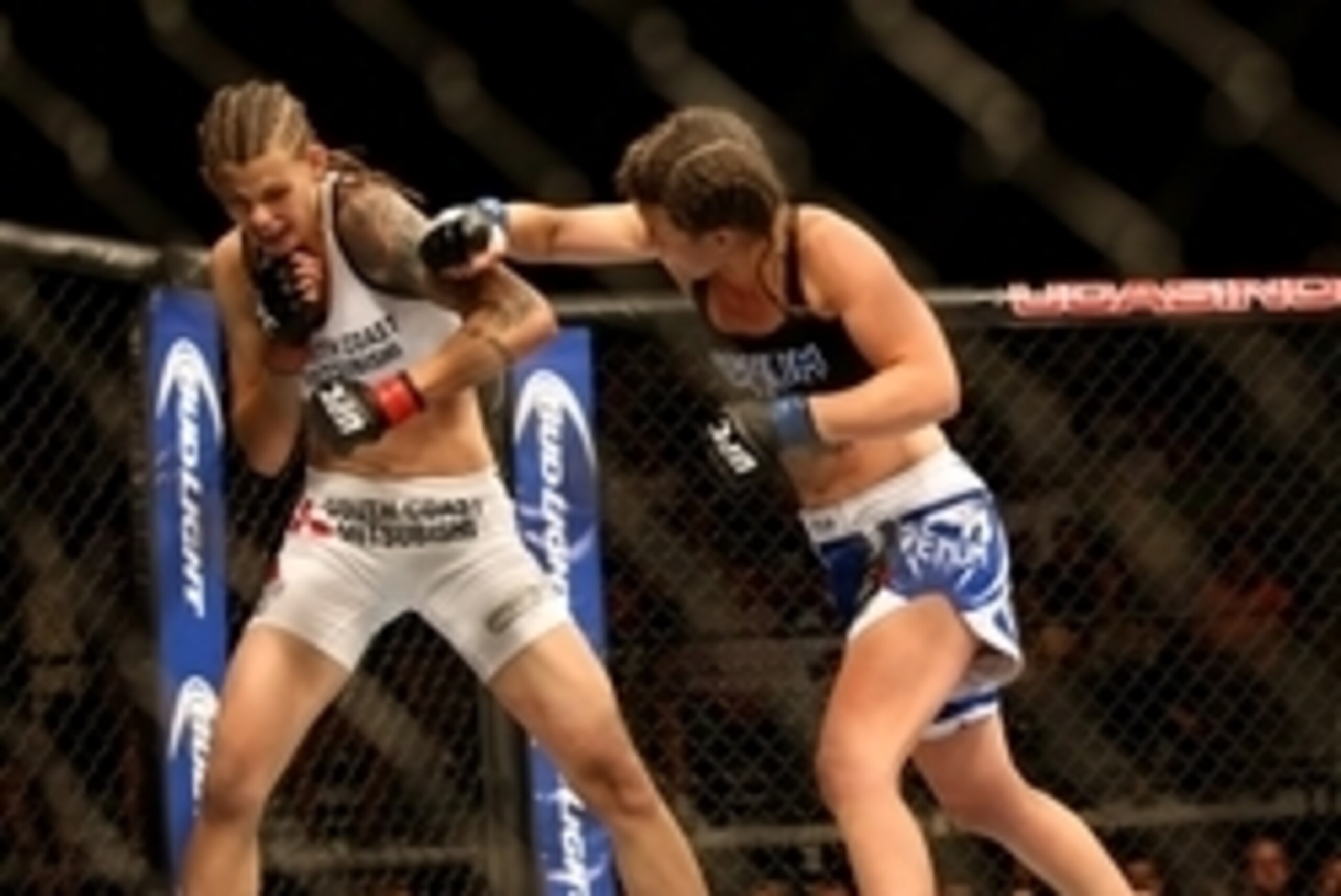 Jul 16, 2014; Atlantic City, NJ, USA; Leslie Smith throws a punch at Jessamyn Duke (red gloves) during a women's bantamweight bout at Revel Casino. Mandatory Credit: Bill Streicher-USA TODAY Sports