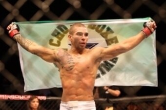 Jul 16, 2014; Atlantic City, NJ, USA; Lucas Martins holds up a flag after winning a featherweight bout at Revel Casino. Mandatory Credit: Bill Streicher-USA TODAY Sports