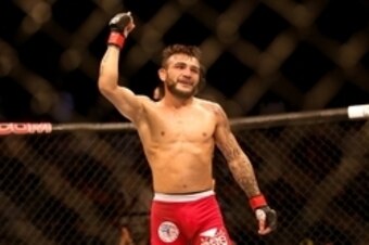 Jul 16, 2014; Atlantic City, NJ, USA; John Lineker shows he is number one after a flyweight bout at Revel Casino. Mandatory Credit: Bill Streicher-USA TODAY Sports
