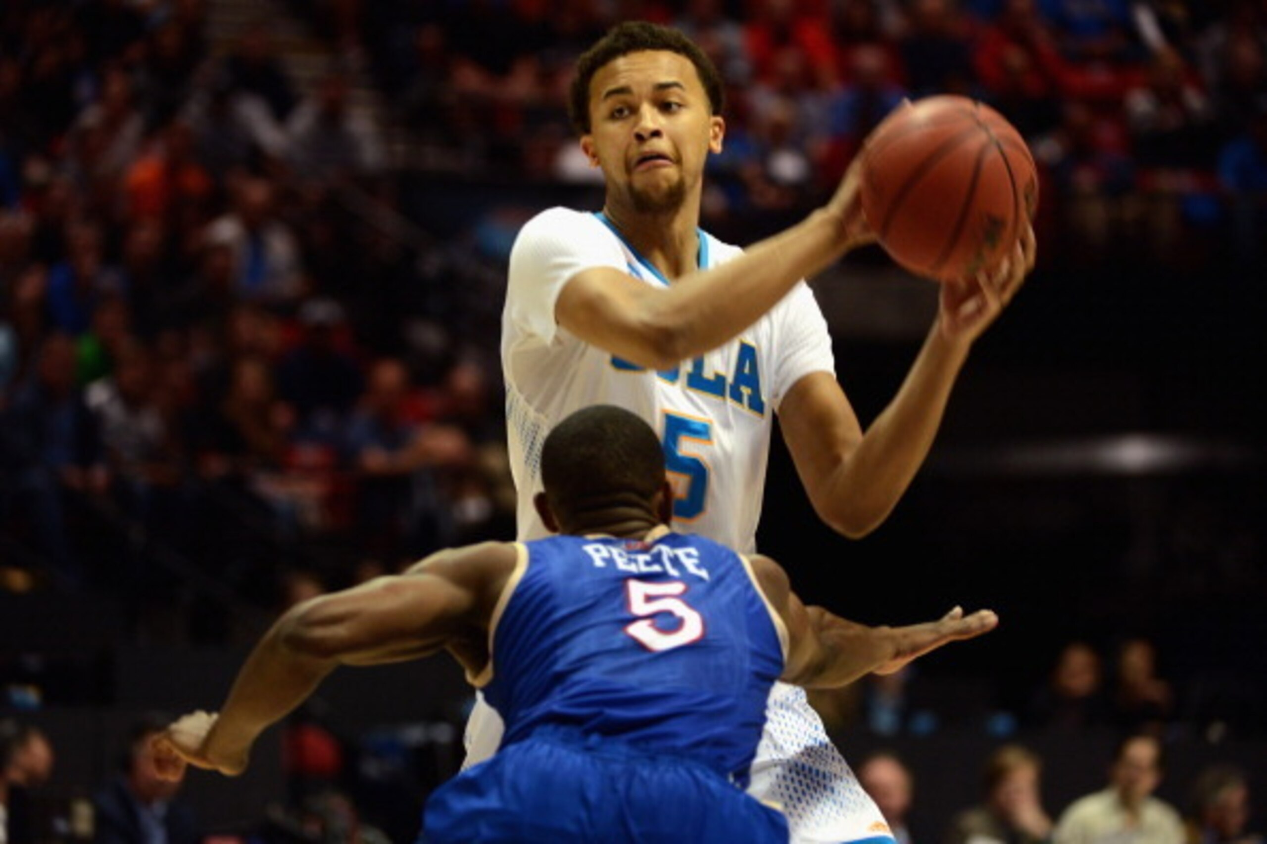 SAN DIEGO, CA - MARCH 21:  Kyle Anderson #5 of the UCLA Bruins looks to pass against Tim Peete #5 of the Tulsa Golden Hurricane during the second round of the 2014 NCAA Men's Basketball Tournament at Viejas Arena on March 21, 2014 in San Diego, California
