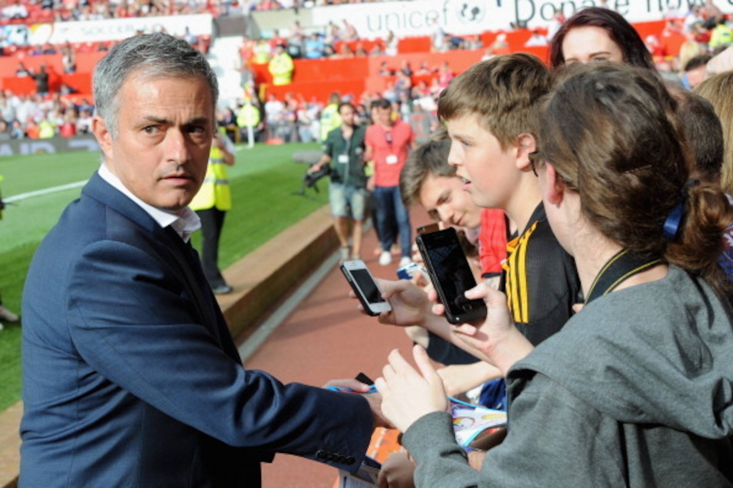 MANCHESTER, ENGLAND - JUNE 08:  Rest of the World manager Jose Mourinho signs autographs for fans ahead of Soccer Aid 2014 at Old Trafford on June 8, 2014 in Manchester, England.  (Photo by Dave J Hogan/Getty Images)
