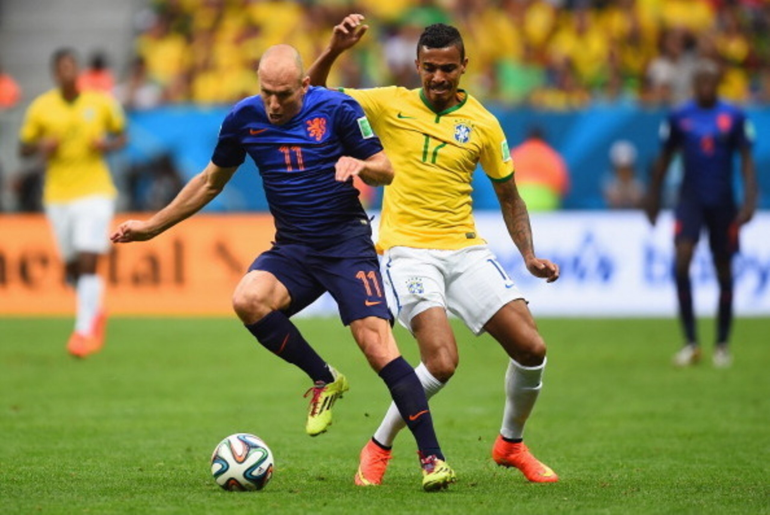 BRASILIA, BRAZIL - JULY 12: Arjen Robben of the Netherlands controls the ball against Luiz Gustavo of Brazil during the 2014 FIFA World Cup Brazil Third Place Playoff match between Brazil and the Netherlands at Estadio Nacional on July 12, 2014 in Brasili