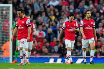 LONDON, ENGLAND - MARCH 29:  A dejected Santi Cazorla, Mikel Arteta and Mathieu Flamini of Arsenal after conceding the first goal during the Barclays Premier League match between Arsenal and Manchester City at Emirates Stadium on March 29, 2014 in London,