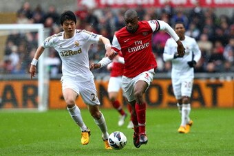 SWANSEA, WALES - MARCH 16:   Abou Diaby of Arsenal battles with Ki Sung-Yueng of Swansea City during the Barclays Premier League match between Swansea City and Arsenal at Liberty Stadium on March 16, 2013 in Swansea, Wales.  (Photo by Jan Kruger/Getty Ima