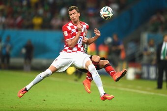 RECIFE, BRAZIL - JUNE 23:  Mario Mandzukic of Croatia and Paul Aguilar of Mexico compete for the ball during the 2014 FIFA World Cup Brazil Group A match between Croatia and Mexico at Arena Pernambuco on June 23, 2014 in Recife, Brazil.  (Photo by Jamie M