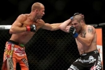 Jul 16, 2014; Atlantic City, NJ, USA; Donald Cerrone (red gloves) throws a punch at Jim Miller (blue gloves) during a 5-round lightweight bout at Revel Casino. Mandatory Credit: Bill Streicher-USA TODAY Sports