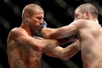 Jul 16, 2014; Atlantic City, NJ, USA; Donald Cerrone (red gloves) locks up with Jim Miller (blue gloves) during a 5-round lightweight bout at Revel Casino. Mandatory Credit: Bill Streicher-USA TODAY Sports